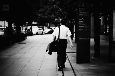 Rear view of woman standing in park