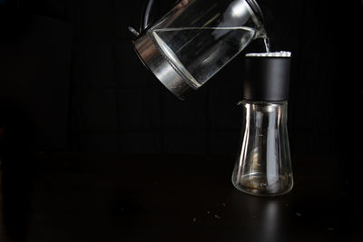 Close-up of coffee on table against black background