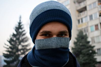 Close-up portrait of man in snow