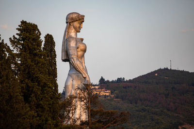 Low angle view of statue against sky