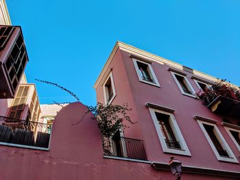 Low angle view of building against clear blue sky