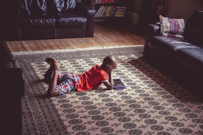 High angle view of man relaxing on sofa at home