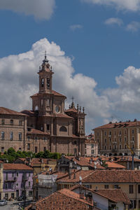 Clouds behind the church of red bricks in fossano, close to the langhe hills of piedmont