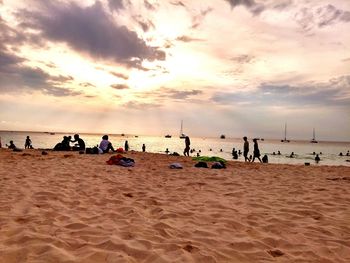 Scenic view of beach against cloudy sky