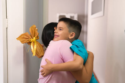 Side view of mother and daughter at home