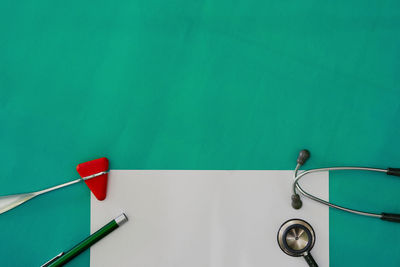 High angle view of stethoscope against blue background