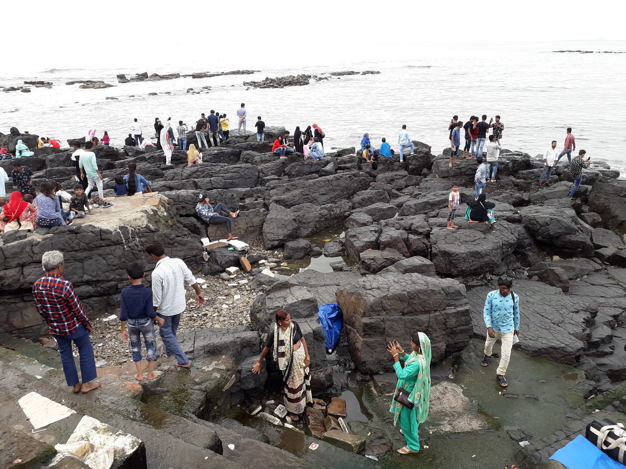 PEOPLE ON BEACH BY SEA