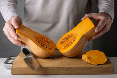 Midsection of man holding pumpkin