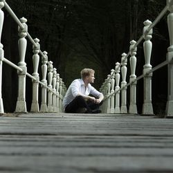 Man sitting on railing