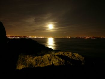 Scenic view of sea against sky at night