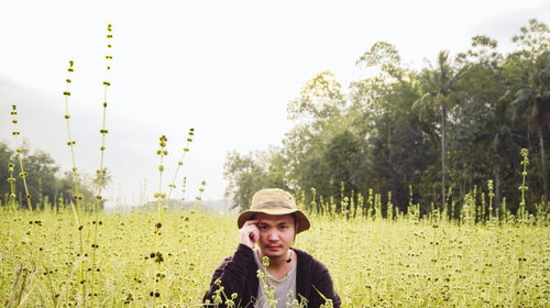 Portrait of young man standing on field