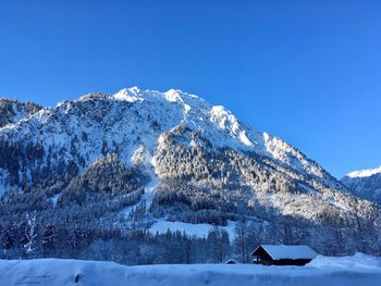 Snowcapped mountains against clear blue sky