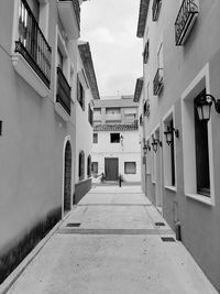 Empty alley amidst buildings in city