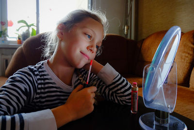 Portrait of smiling girl on table