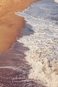 High angle view of waves rushing towards shore