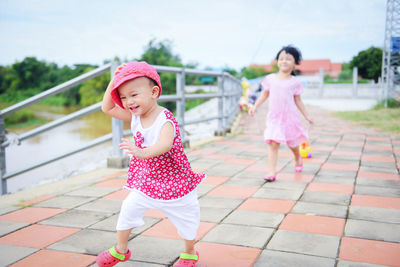 Portrait of happy girl with pink umbrella
