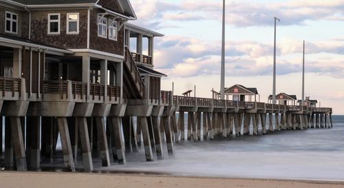 Row of houses on beach against sky