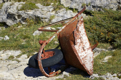 Abandoned wheelbarrow on field