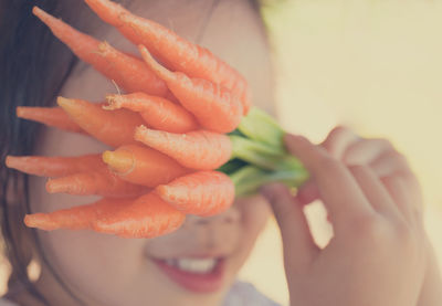 Close-up of hand holding orange