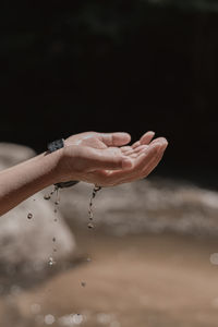 Close-up of hand holding water drop