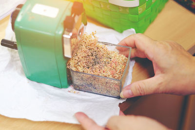 Close-up of hand holding pencil shaving