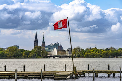 Flag by building against sky