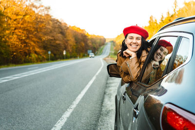 Portrait of young woman in car