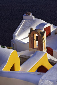 High angle view of yellow building by sea