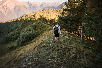 Rear view of man walking on mountain 