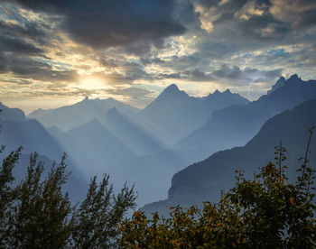 Scenic view of mountains against sky at sunset