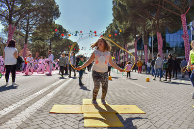 Girl jumping with jump rope on street