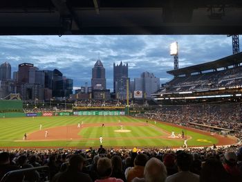 Crowd in city against sky