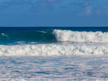 Scenic view of sea against blue sky