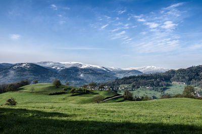 Scenic view of landscape and mountains against sky