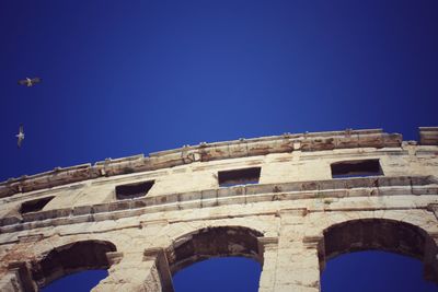 Low angle view of historical building against blue sky