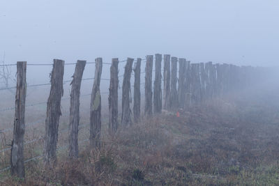 Panoramic view of wooden fence on landscape against sky