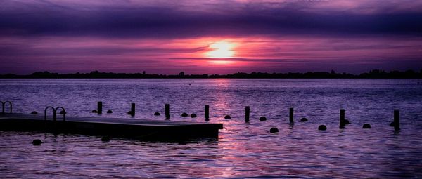 Scenic view of lake at sunset