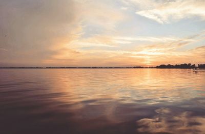 Scenic view of calm sea at sunset
