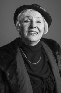 Portrait of smiling woman against gray background