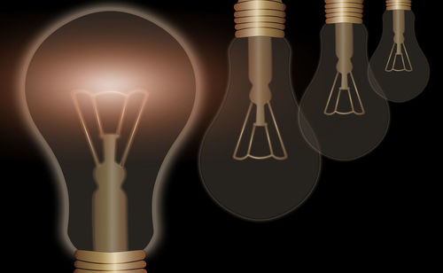 Digital composite image of light bulb against black background