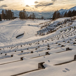 Snow covered land and mountains against sky