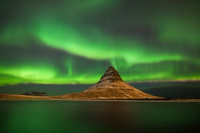 Scenic view of mountain against sky at night