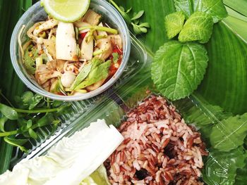 High angle view of food served in container on leaves