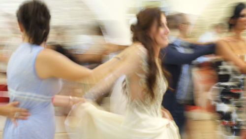 Young woman with arms raised in store