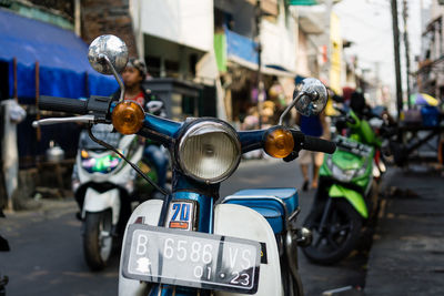 Close-up of motor scooter on street