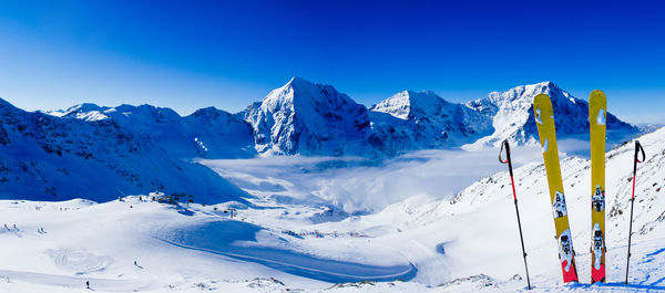 Scenic view of snowcapped mountains against clear blue sky