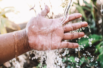 Close-up of man hand holding water