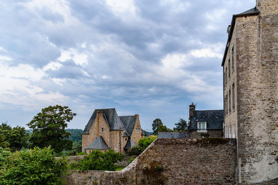 Old cobblestoned street with stone medieval houses in the town centre of dinan, french brittany