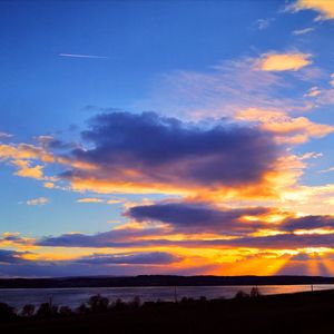 Scenic view of silhouette land against sky during sunset