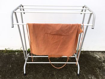 Close-up of empty chair against wall